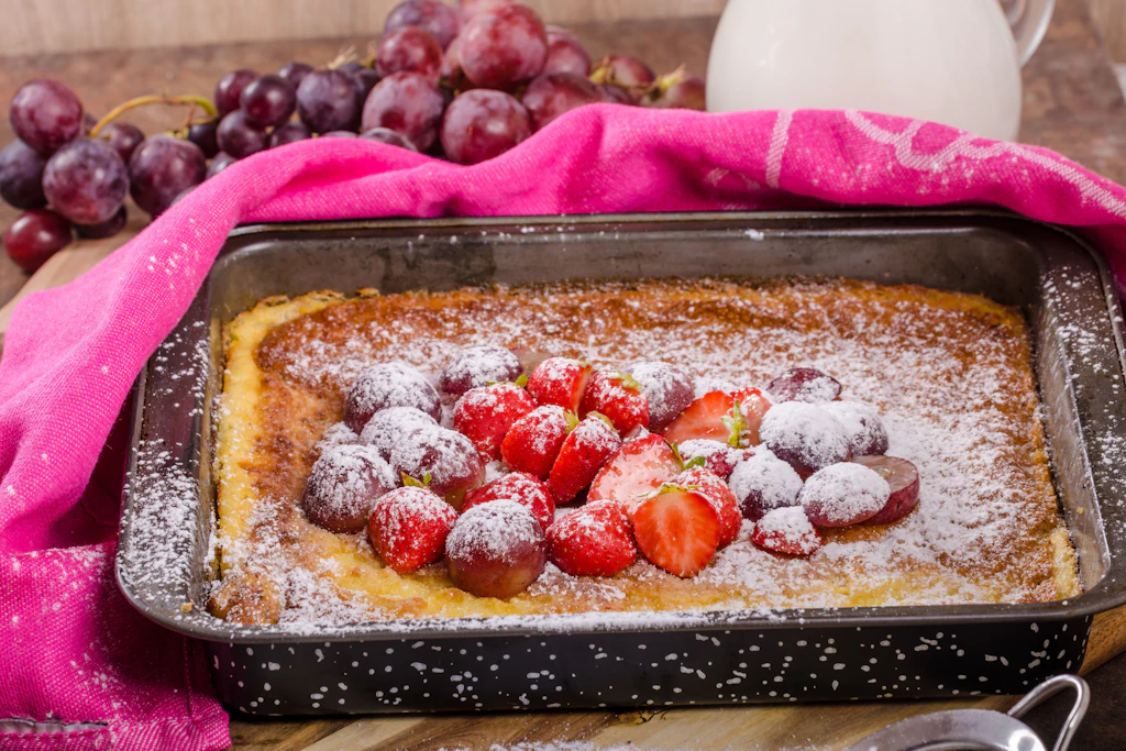 Mit Puderzucker garniert und mit Früchten belegt, so schmeckt der Pfannkuchen vom Blech einfach himmlisch!