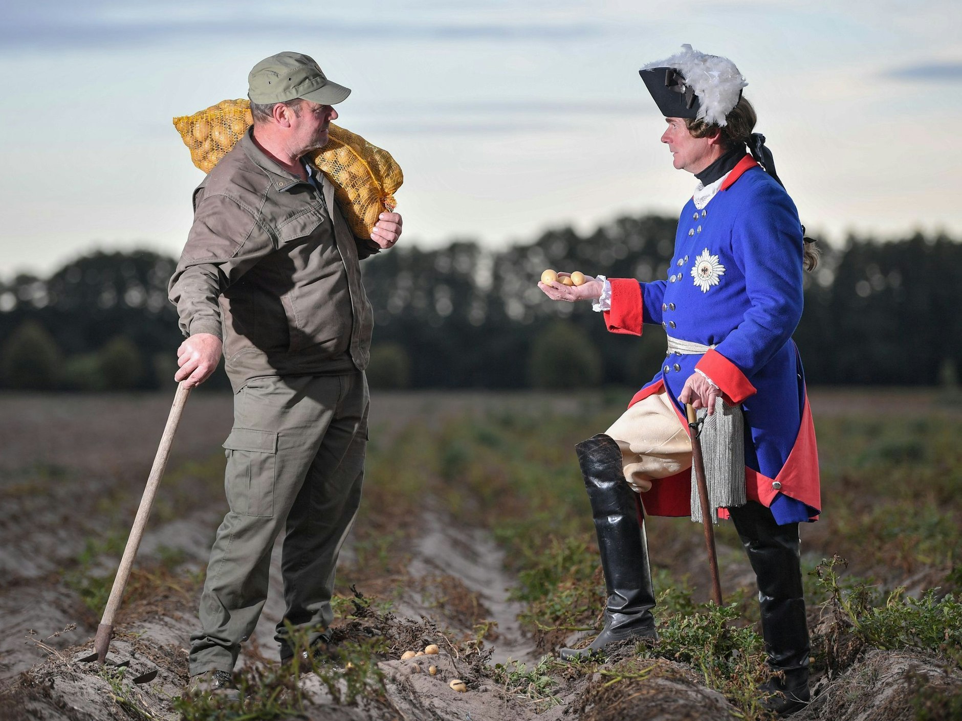 Heutzutage ist die Ankunft der Kartoffel in Preußen schon Folklore: Hier steht Lutz Werner, Stadtführer in Storkow, verkleidet als Friedrich der Große auf einem Acker und unterhält sich mit dem Bauern Fritz-Walter Peter über seine Kartoffelernte.