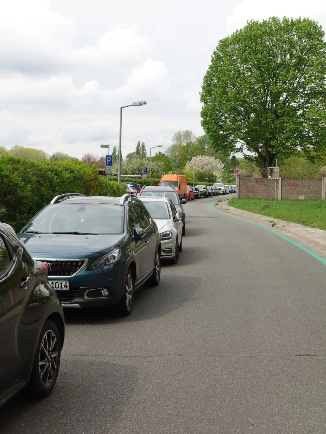 Charles-Corcelle-Ring: Die Autos dürfen hier bald nicht mehr parken, da alles zu einer Fahrradstraße umgewandelt wird. Das zeigen die grünen Fahrbahnmarkierungen schon an.