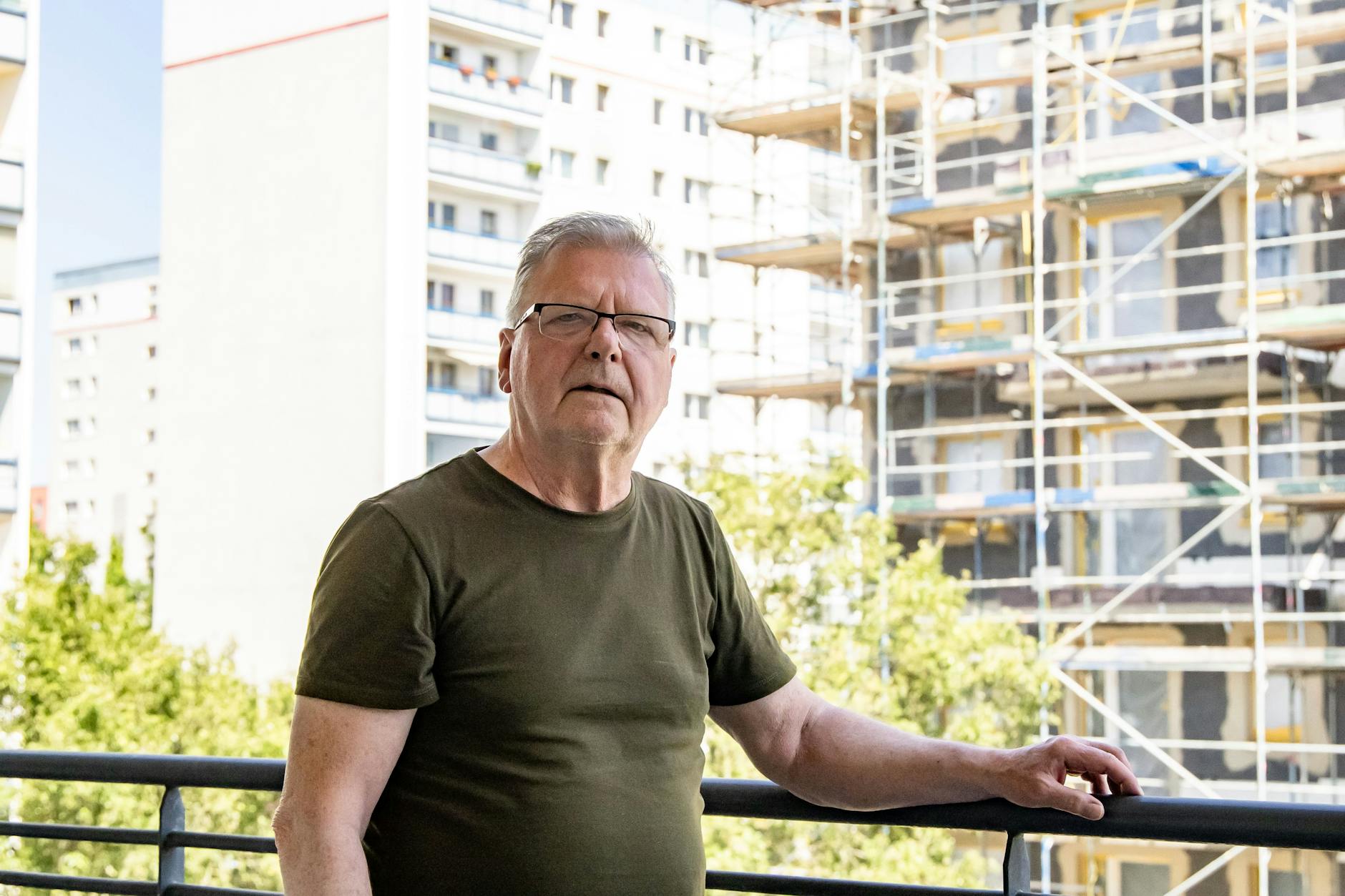 Axel Matthies auf seinem Balkon am U-Bahnhof Kaulsdorf Nord, rechts der Rohbau