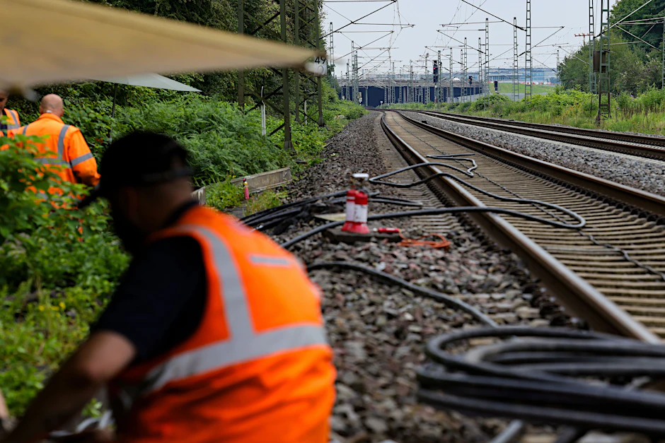 Mitarbeiter der Deutschen Bahn bei der Repatarur von Kabeln an einem Gleisabschnitt in Düsseldorf, nachdem neben der Bahnstrecke Feuer in einem Kabeltunnel gelegt wurde.