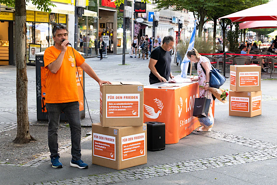 „Ohne Frieden keine Demokratie“, sagen die Aktivisten Jens K. und Roy B. (v.l.) und fordern ein Ende von Kriegshetze und Aufrüstung.