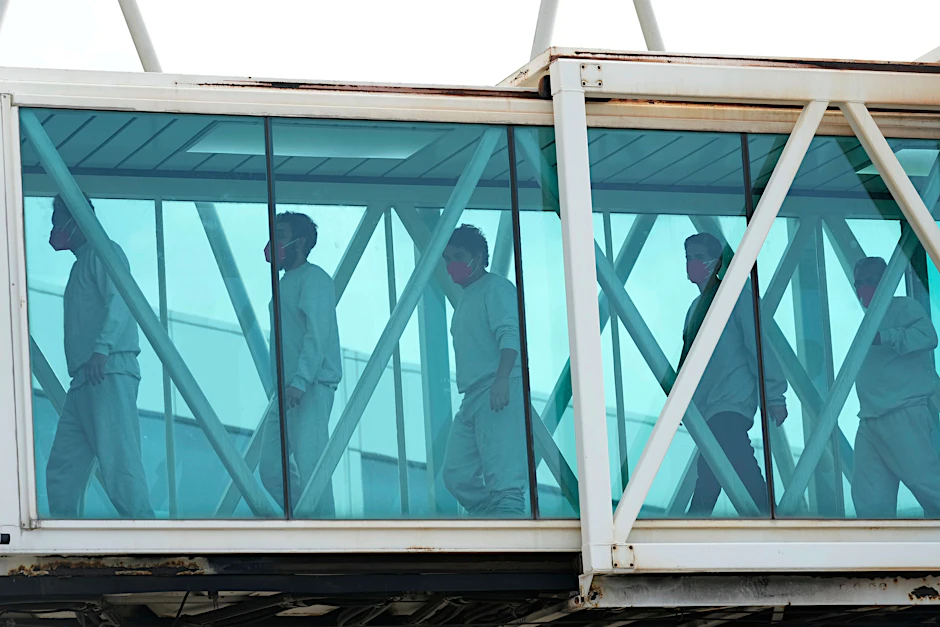 Aus den USA abgeschobene Migranten steigen in Venezuela aus dem Flugzeug. Uganda wird unter Auflagen abgeschobene Migranten aus den USA aufnehmen.