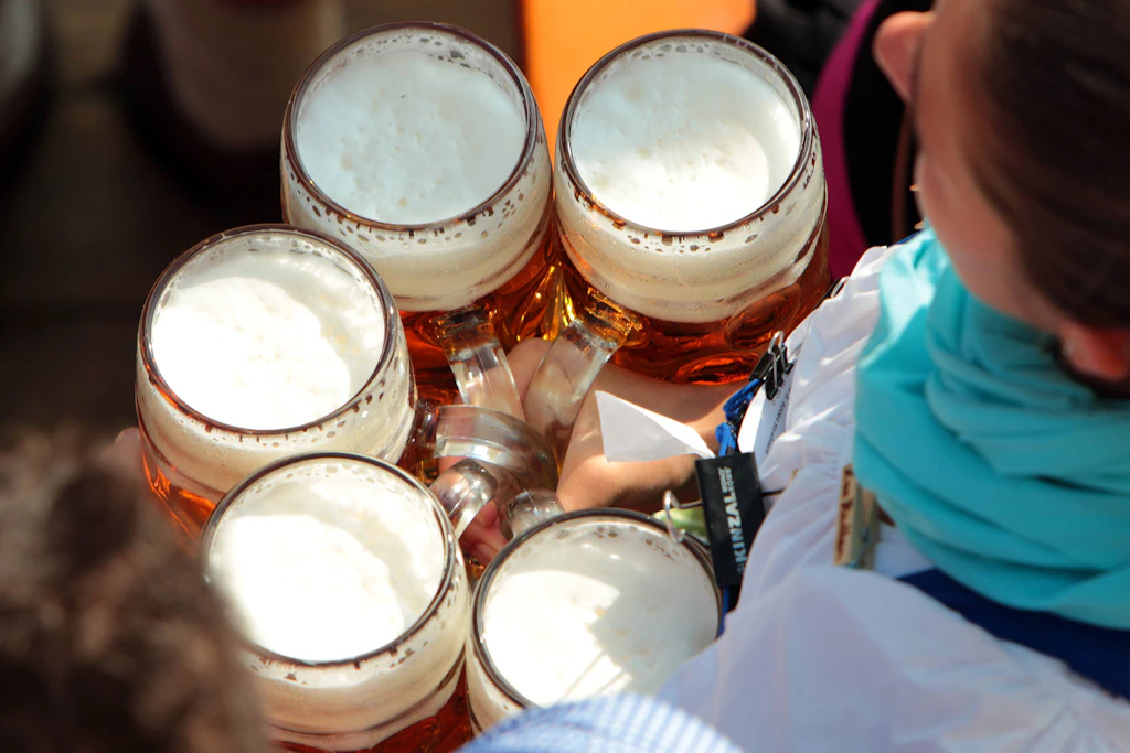 Eine Kellnerin trägt Maßkrüge in einem Festzelt.