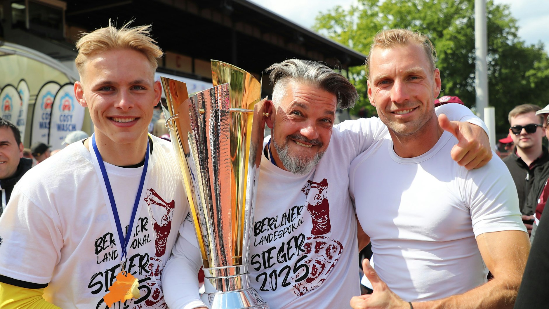 Udo Gans (M.) und die BFC-Torhüter Paul Hainke (l.) und Kevin Sommer präsentieren im Mai 2025 stolz den Berliner Pokal.
