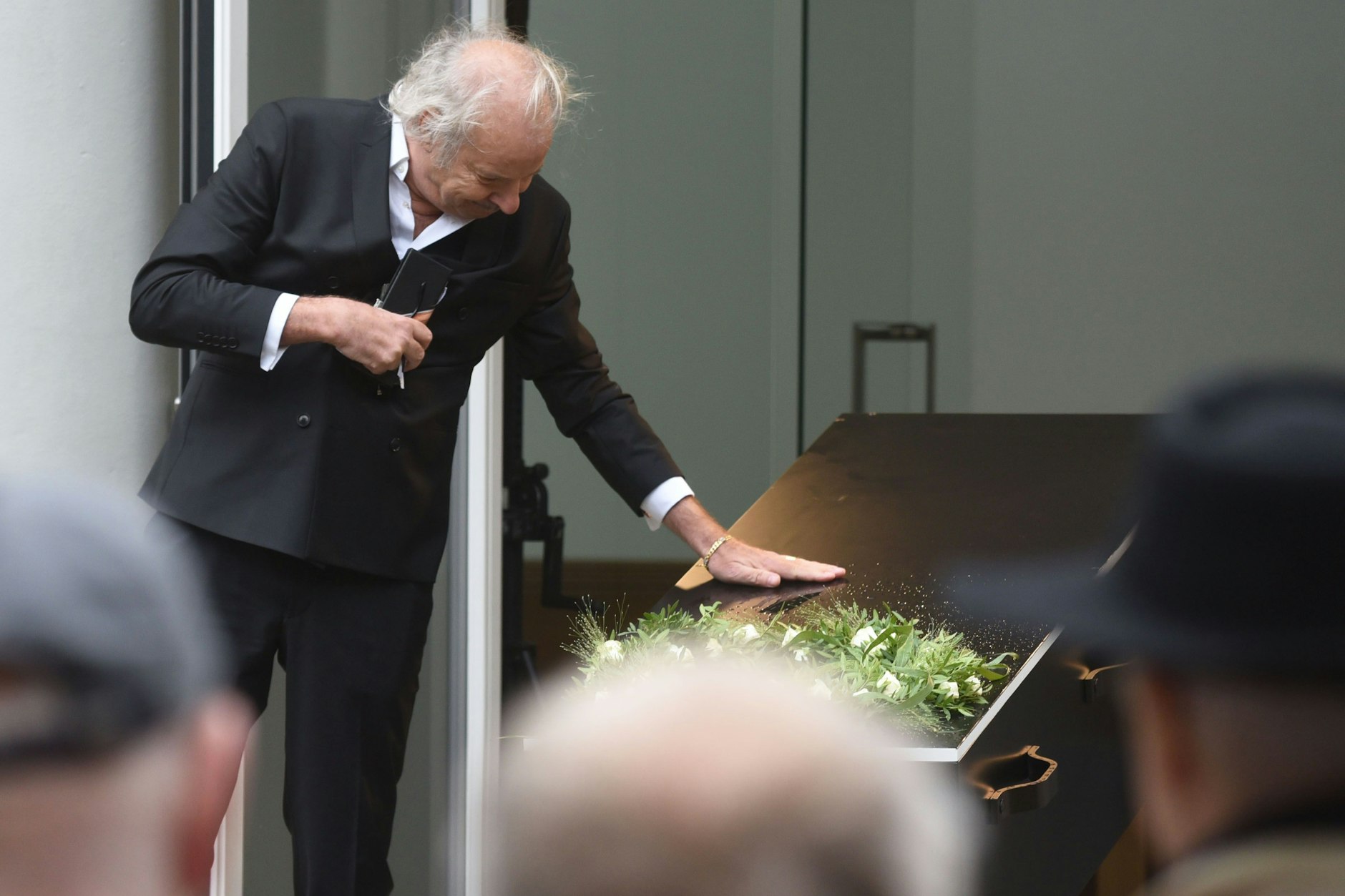 Leander Haußmann verabschiedet sich am Sarg von seinem Freund Claus Peymann.