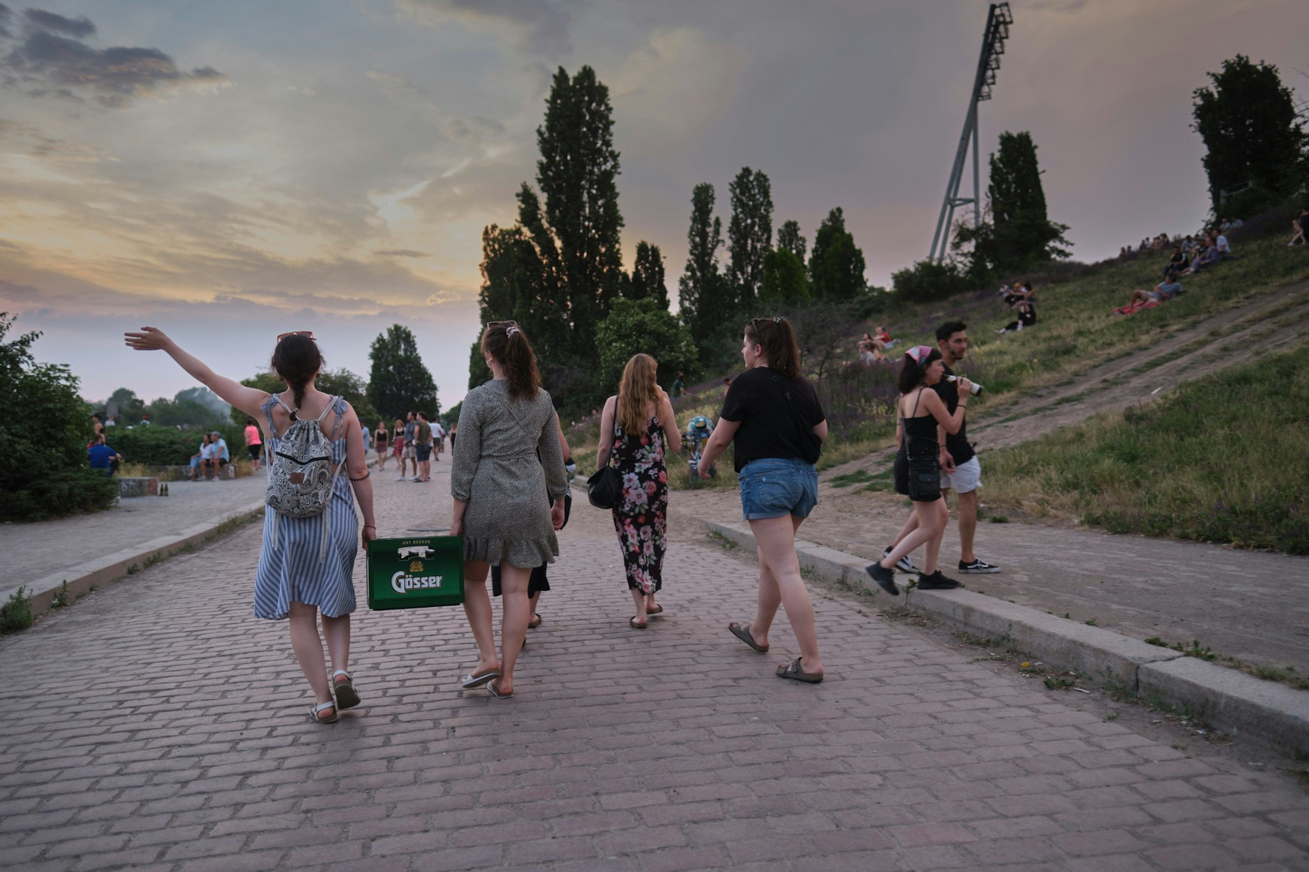Eine Gruppe junger Frauen mit einem Kasten Bier im Mauerpark