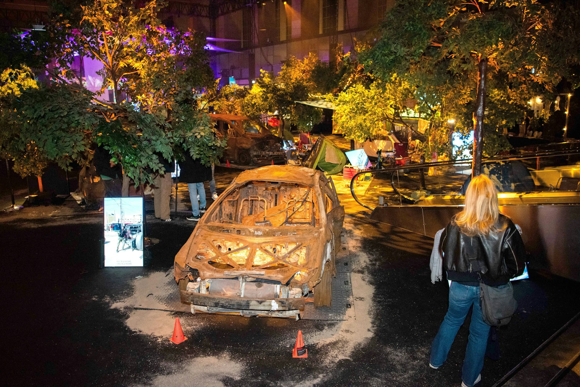 Ein ausgebranntes Auto vom israelischen Musikfestival ist im Rahmen der Berliner Schau zu sehen.