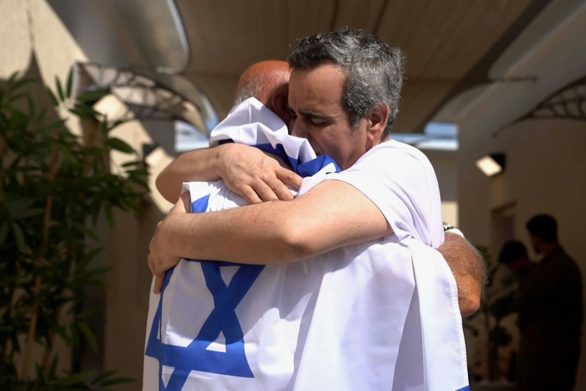 Auf diesem von den israelischen Verteidigungskräften zur Verfügung gestellten Foto umarmt die befreite Geisel Omri Miran (r) eine nicht identifizierte Person