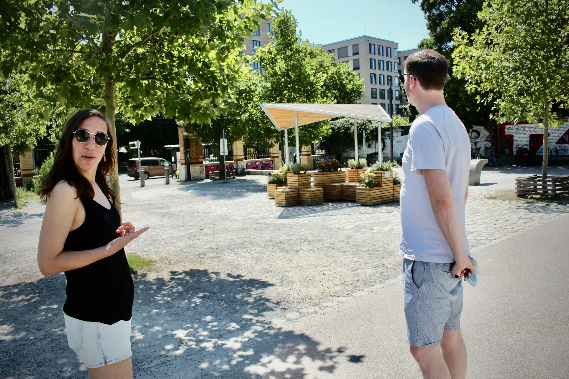 Touristen spotten über Berlins Cooling-Point: Nathalie von Grote und ihr Freund Ian Green aus England ziehen den Schatten der Bäume vor.