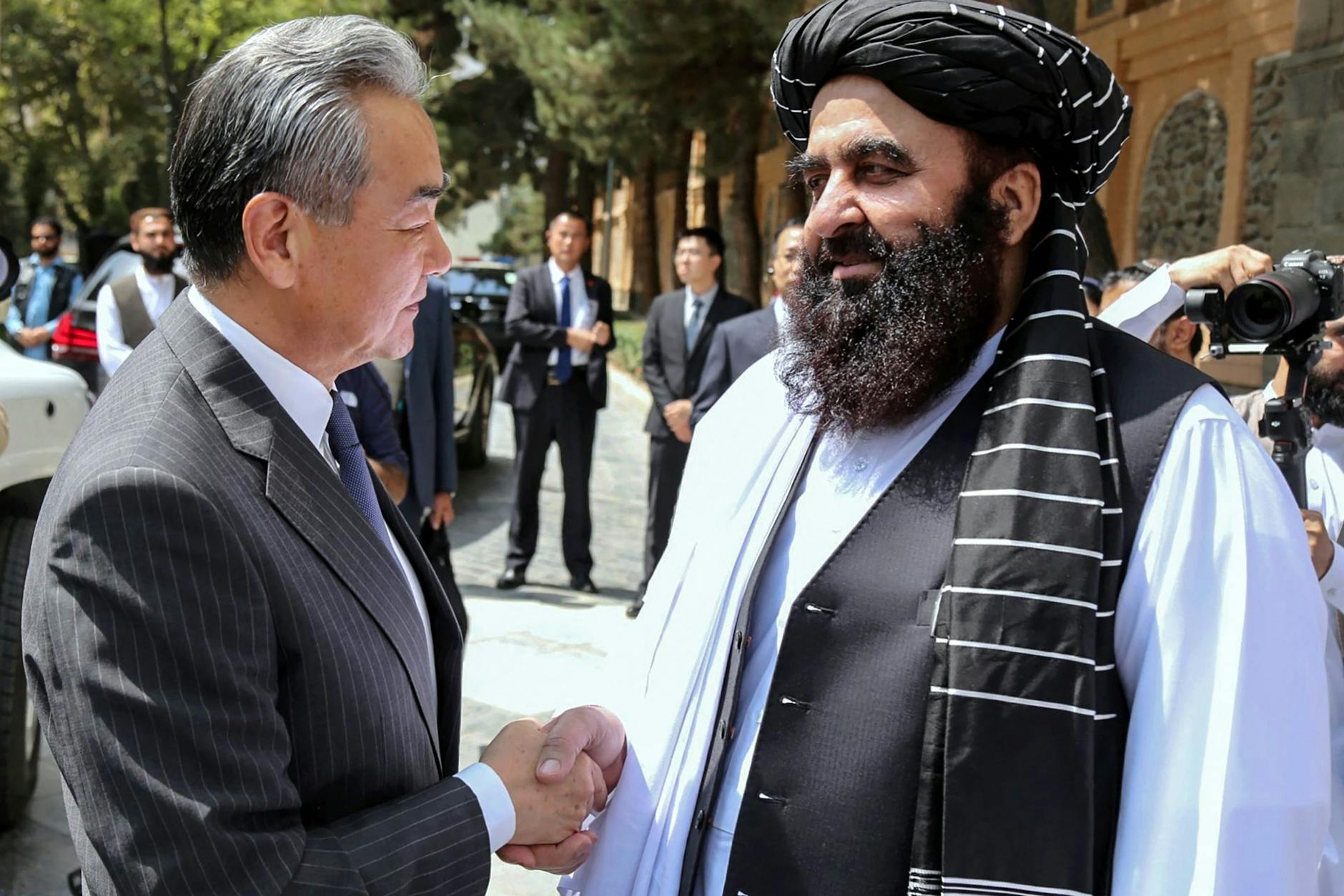 Afghanistans Außenminister Amir Khan Muttaqi begrüßt Chinas Außenminister Wang Yi vor ihrem Treffen in Kabul.