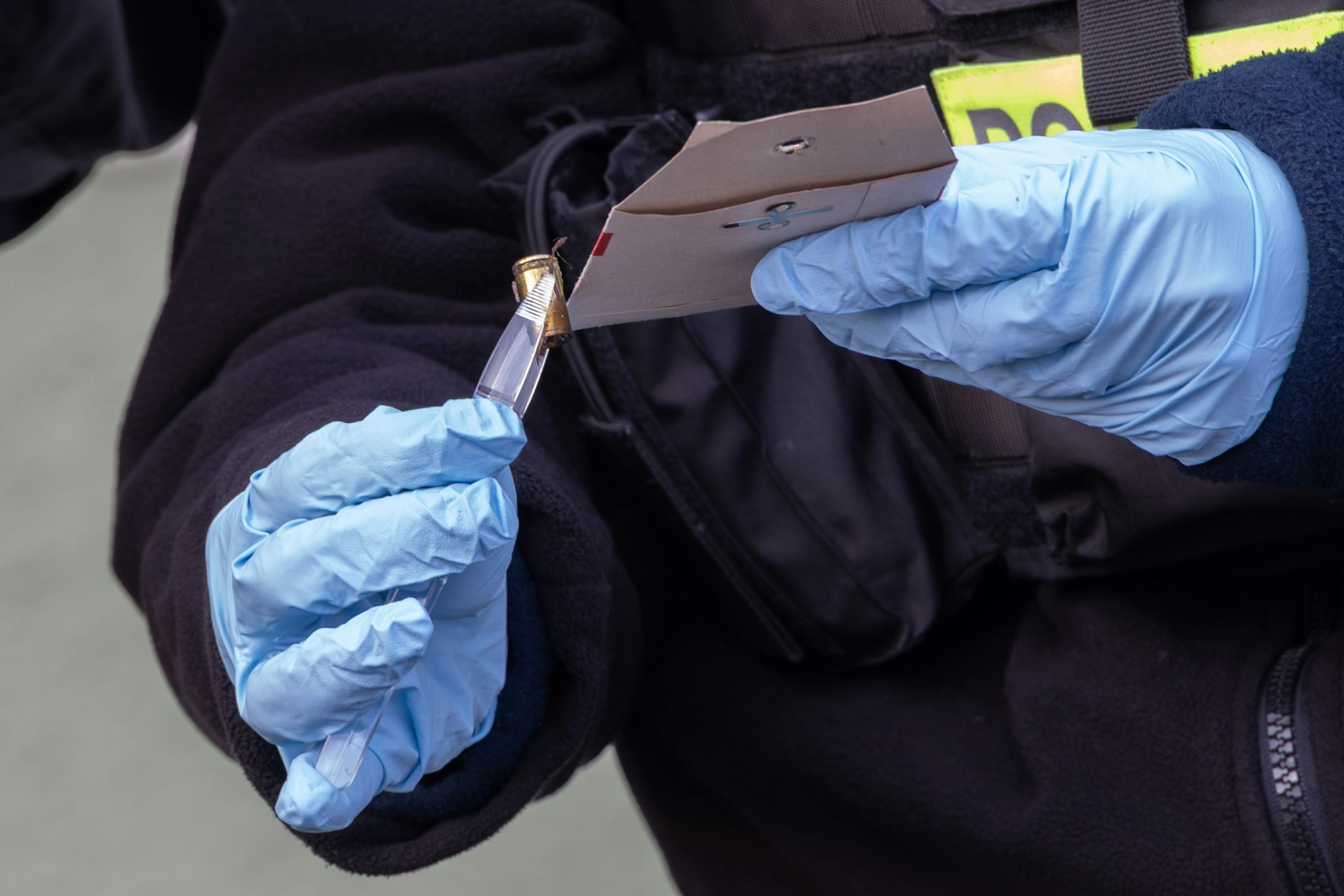 Eine Patronenhülse wird von der Polizei als Beweismittel gesichert.