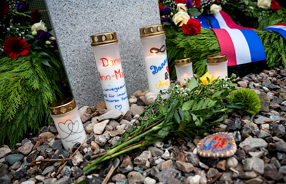 Kerzen, Blumen und Kränze stehen und liegen zum Gedenken an die Messerattacke von Brokstedt im Jahr 2023 auf dem Bahnhof.
