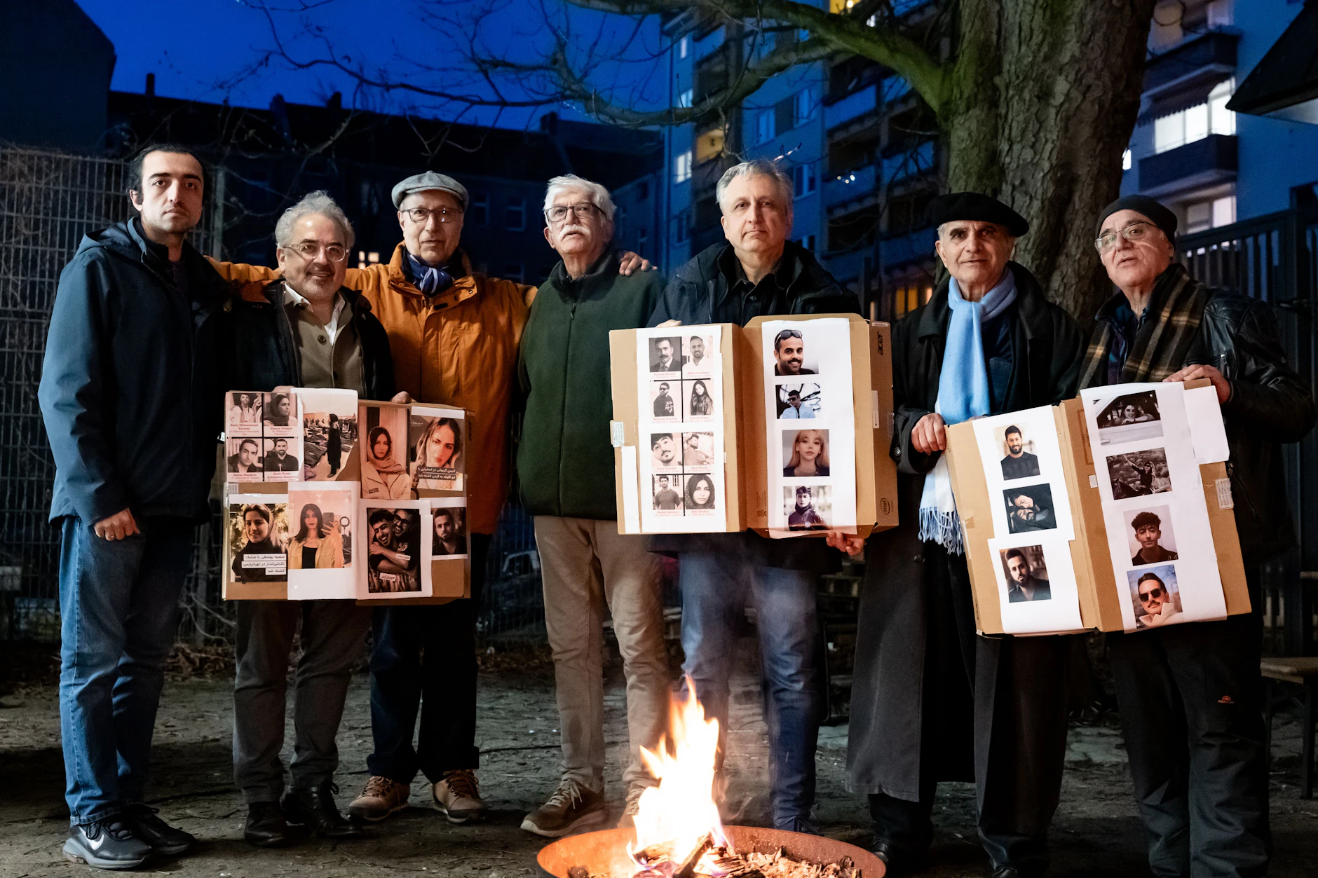 Mitglieder der Iranischen Gemeinde halten Bilder von Menschen in die Höhe, die während der Proteste im 
Januar getötet wurden.