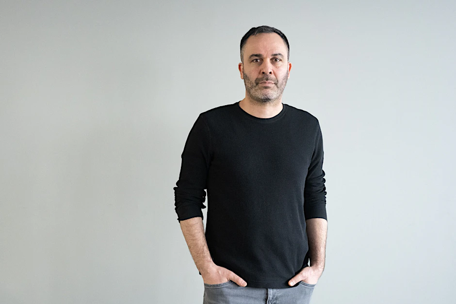 Journalist Hüseyin Dogru posiert für ein Foto im Berliner Verlag.
