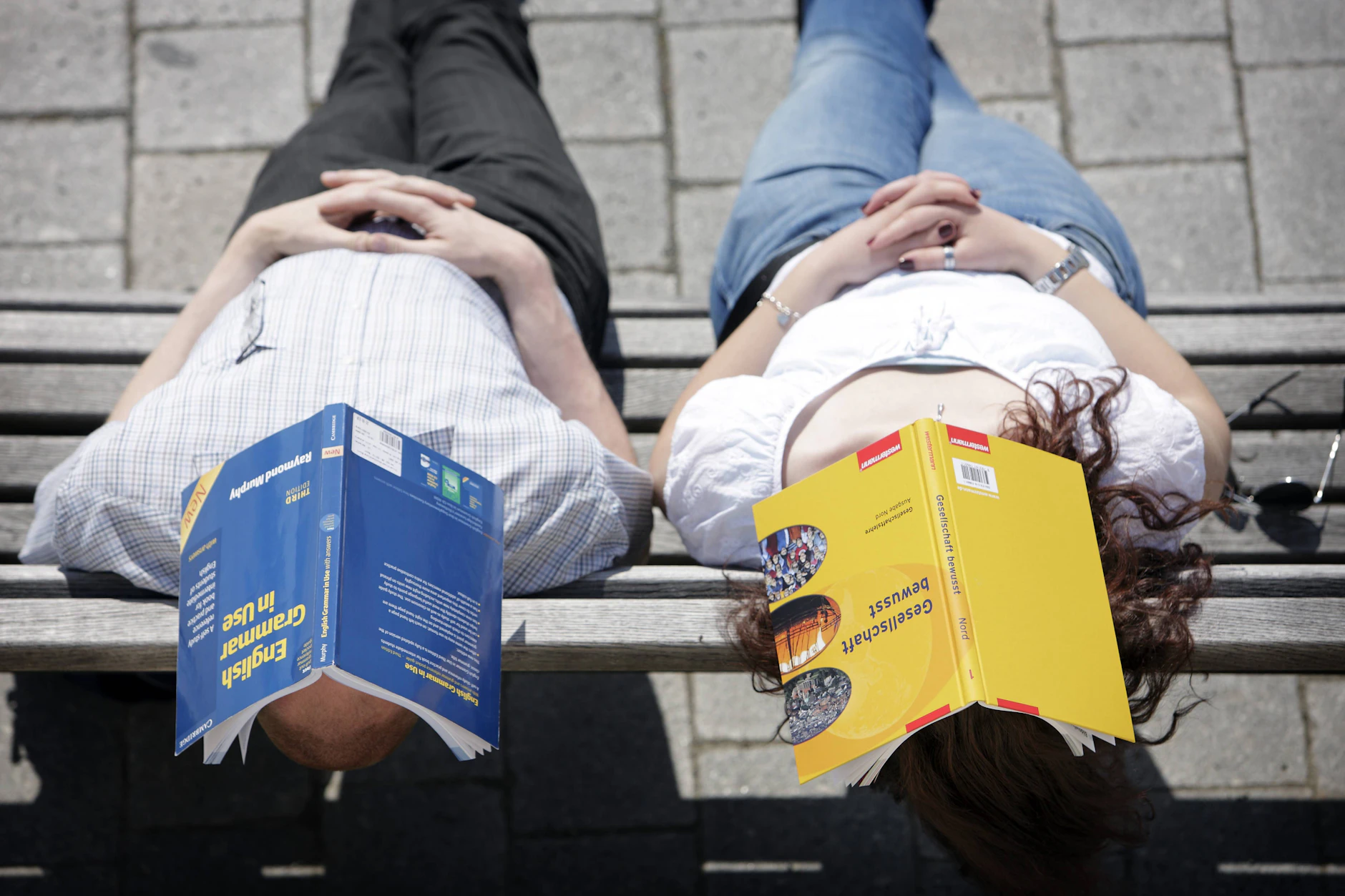 Lektüre zu anstrengend: Studenten nutzen Bücher als Sonnenschutz.