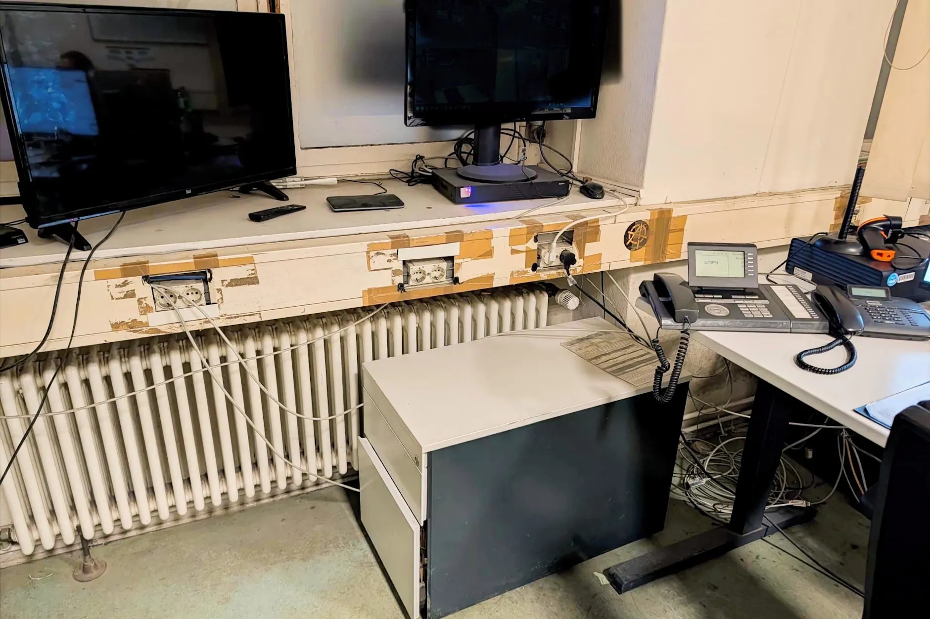 So sieht es im Polizeiabschnitt 52/53 in Kreuzberg aus. Die Monitore, die den Parkplatz überwachen, stehen im Fenster.