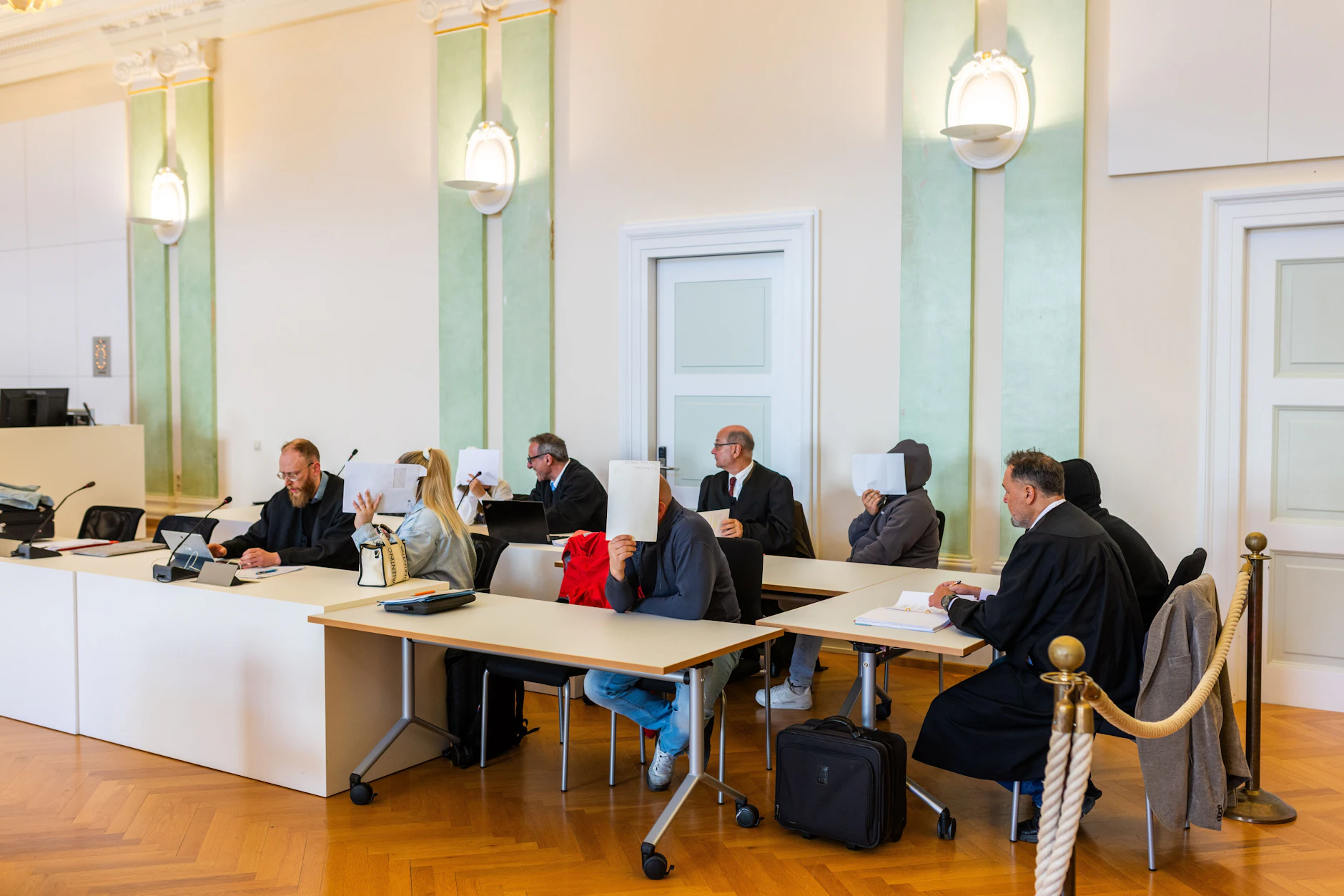 Die fünf Angeklagten im Ikea-Fall und ihre vier Verteidiger sitzen im Amtsgericht Freiburg. Die hauptangeklagte Kassiererin fehlte.