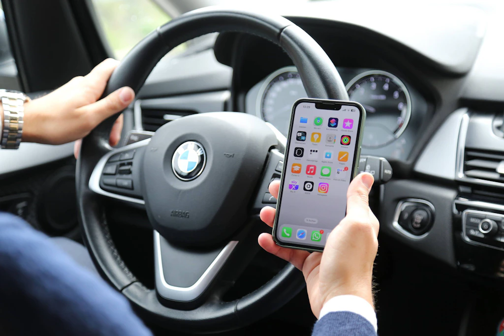 Der Ablenkungswarner im Auto gibt auch ein Signal, wenn der Autofahrer sich nicht auf den Verkehr konzentriert, sondern mit dem Handy spielt.