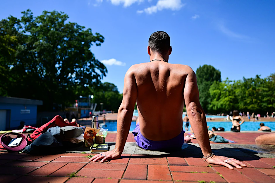 Ein Mann sitzt im Sommerbad Kreuzberg. Seit 2023 gibt es an den Kassen einzelner Bäder Videoüberwachung und Ausweiskontrolle.