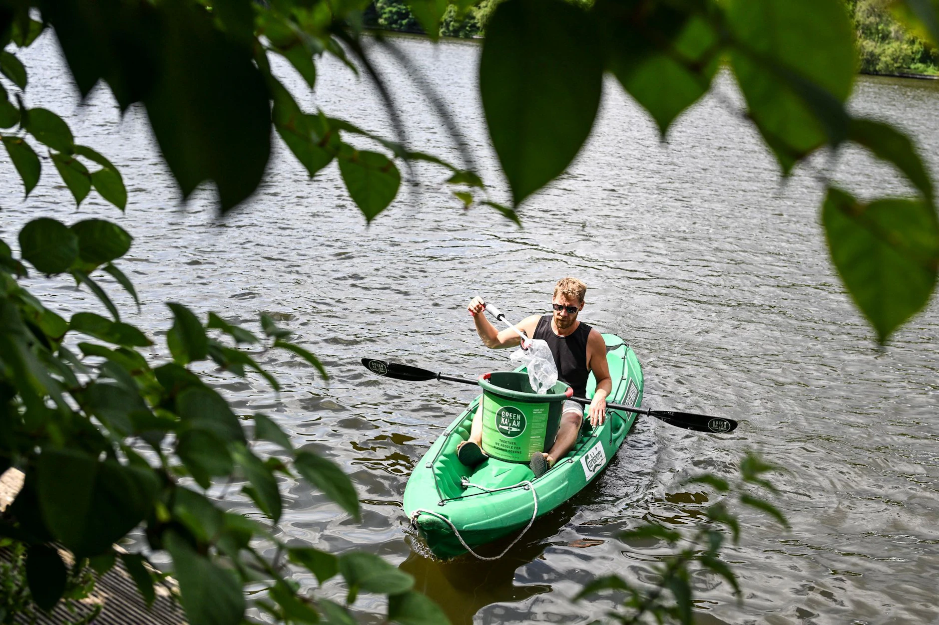 Sebastian Bunk, Geschäftsführer von Backstagetourism, sammelt in einem „Green Kayak“ Müll aus der Spree.