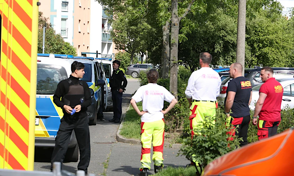 Einsatzkräfte stehen vor dem Wohnhaus in Hellersdorf. Dort starb ein Mann durch zahlreiche Messerstiche.