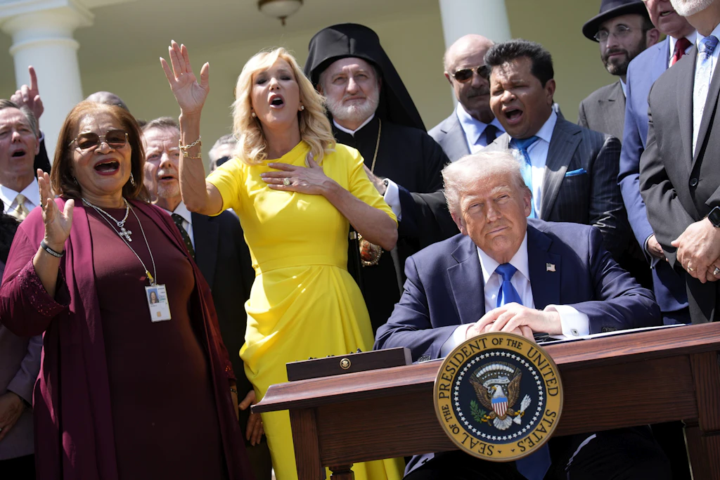 Donald Trump genießt sichtlich, was Paula White (gelbes Kleid) vor dem Weißen Haus über ihn kundtut.
