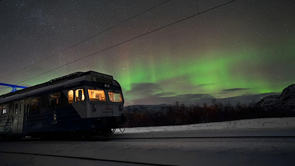 Ein Zug unterwegs nach Narvik im Norden von Norwegen. In der kalten Jahreszeit sind nördlich des Polarkreises Polarlichter zu sehen.