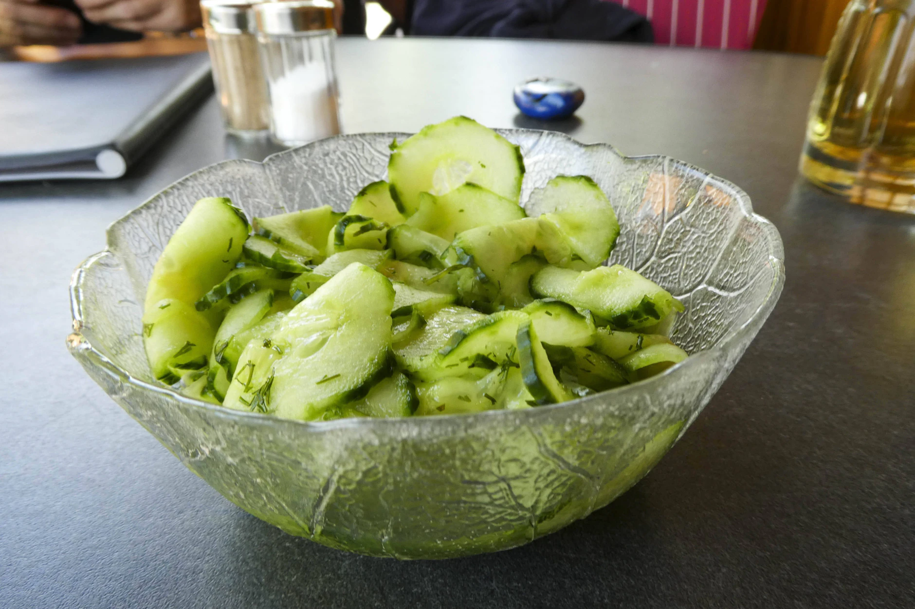 Die so zubereiteten Gurken sind perfekt für heiße Tage. Die Zutaten sind einfach: Salatgurken, Zwiebeln und Dill.