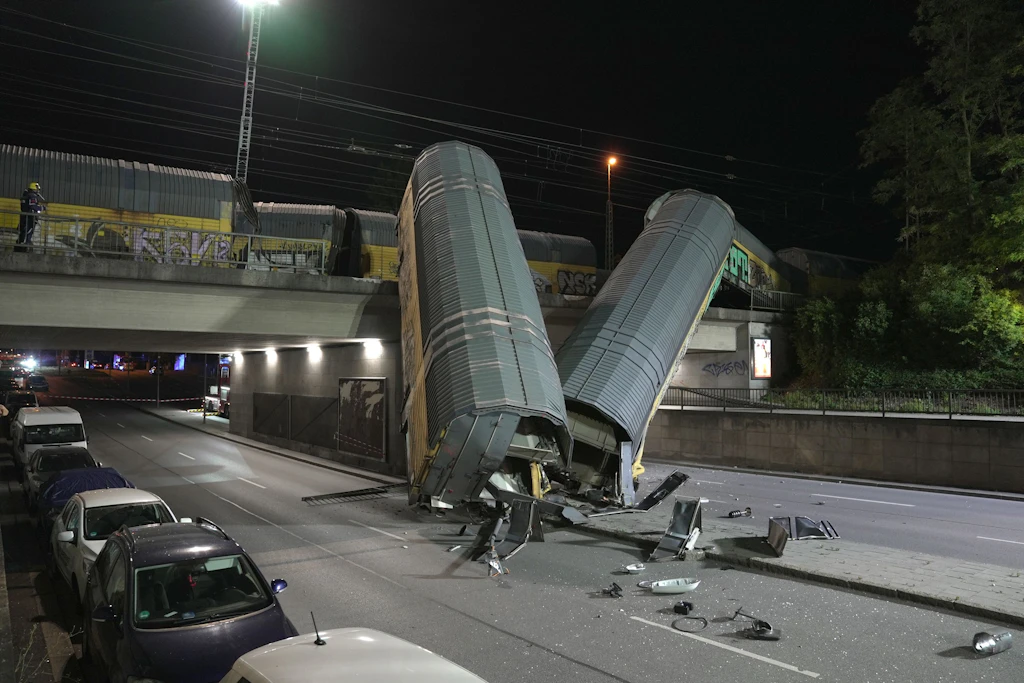 Zwei Güterzug-Waggons stürzen in München von Brücke