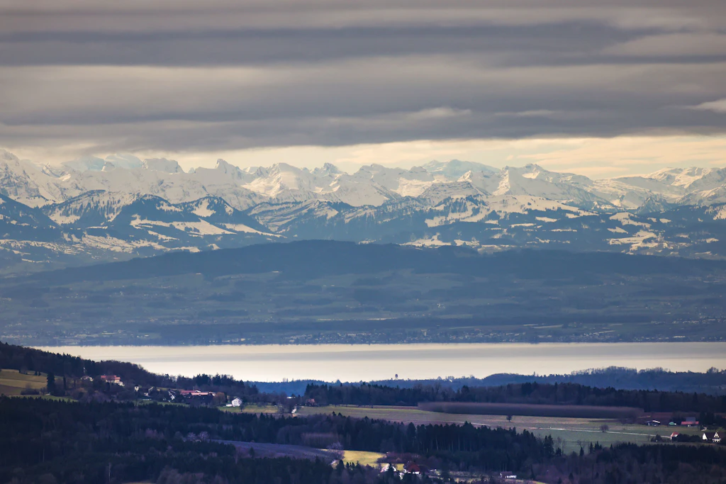 Schneebedeckte Alpengipfel über dem noch grünen Vorland: In der Nacht zum Donnerstag sinkt die Schneefallgrenze auf etwa 2200 Meter, in den höchsten Lagen fallen wenige Zentimeter Neuschnee.