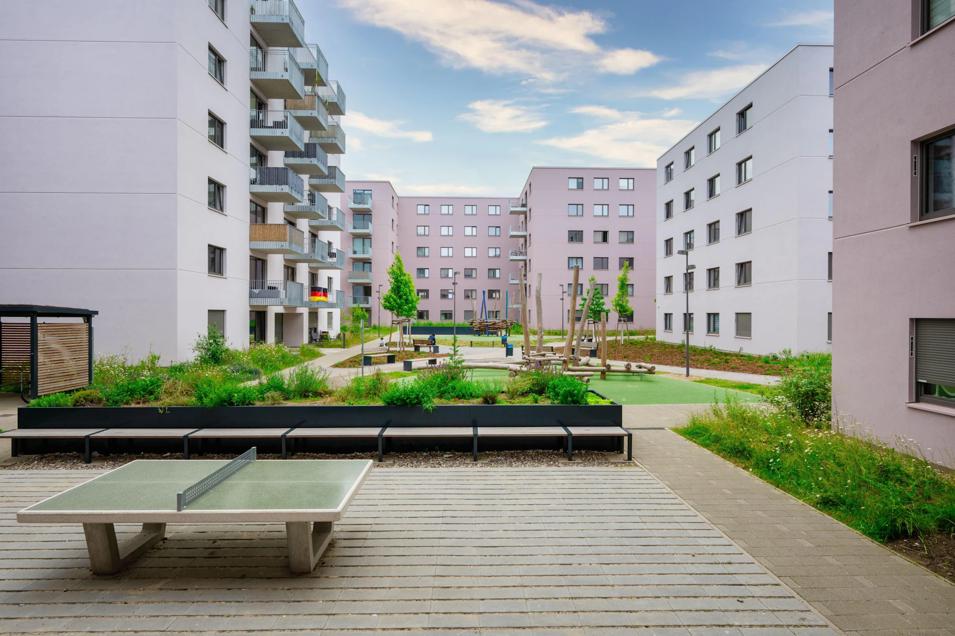 Im begrünten Innenhof gibt es einen neuen Spielplatz und eine Sitzecke mit Ping-Pong-Platte.