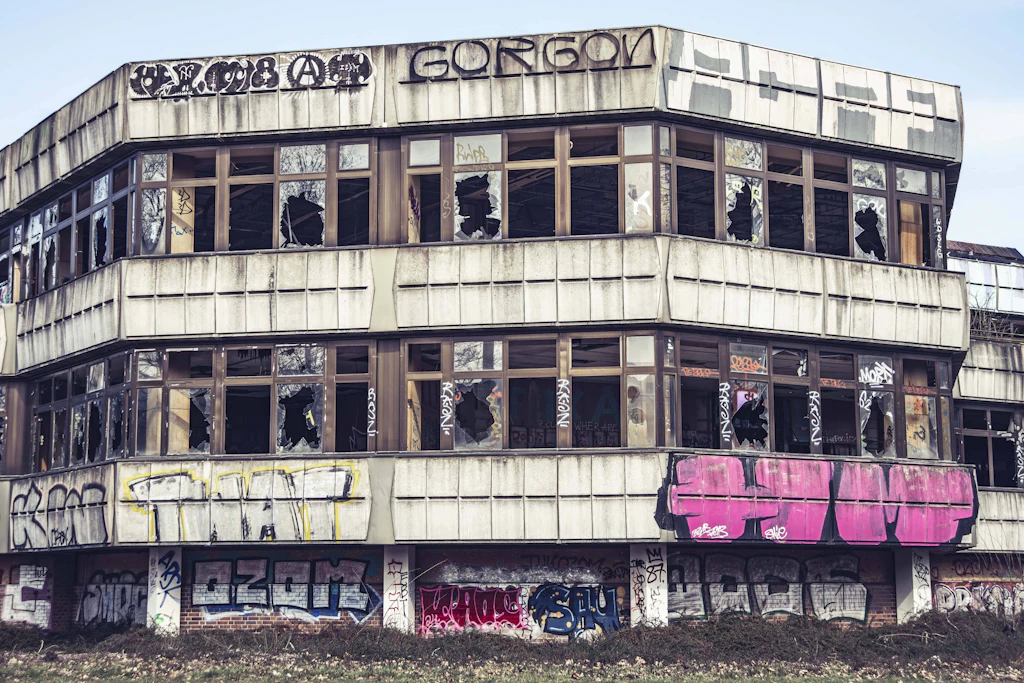 Eingeschlagene Scheiben über drei Etagen, Graffiti bis unters Dach: Das frühere DDR-Sporthotel am Weißenseer Weg in Hohenschönhausen. Auf dem Areal sollen rund 570 Wohnungen und ein Hochhaus mit bis zu 16 Geschossen entstehen.