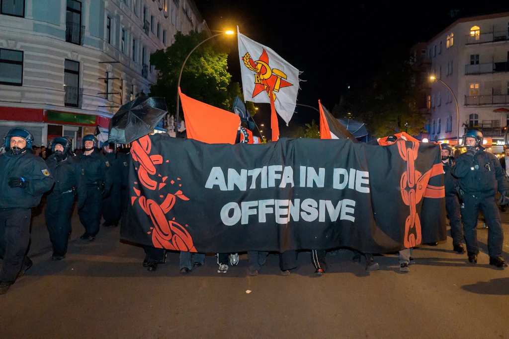 May 1, 2026, Berlin, Berlin, Germany: Head banner of the black bloc that writes Antifa in the Offensive surrounded by heavy police force on May 1st, Berlin, Germany. Thousands of people march at the streats of Berlin Kreuzberg/NeukoÂln for the annual demonstration of International Worker s Day, with intense pro-Palestine character and police-violence at the end of the deomnstration. Berlin Germany - ZUMAk201 20260501_zip_k201_010 Copyright: xNikosxKanistrasx