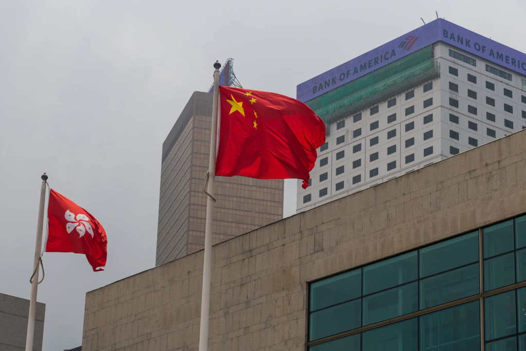 Chinesische und Hongkonger Flaggen vor einem Bankgebäude in Hongkong