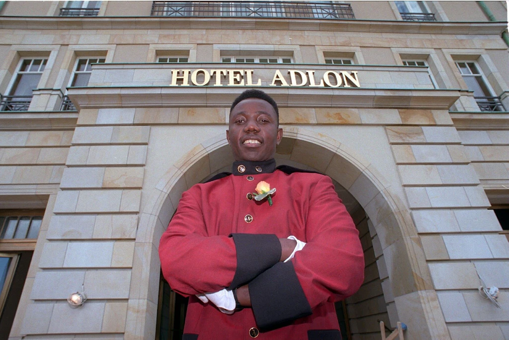 Begrüßung in schmucker Uniform: Hoteldiener Joseph Nyarko im Eröffnungsjahr vor dem Haupteingang des Hotels Adlon am Brandenburger Tor