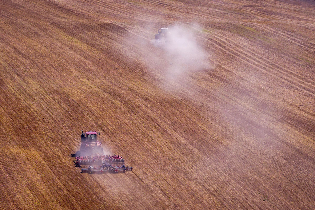 Traktoren bearbeiten einen Acker: Die große ukrainische Landwirtschaft stellt die EU bei den Beitrittsbedingungen vor schwierige Verteilungsfragen.