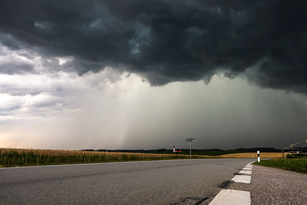 Regenschleier unter einer Gewitterzelle über einem Getreidefeld (Symbolbild): Am Freitagnachmittag erreichen die Gewitter Ostdeutschland.