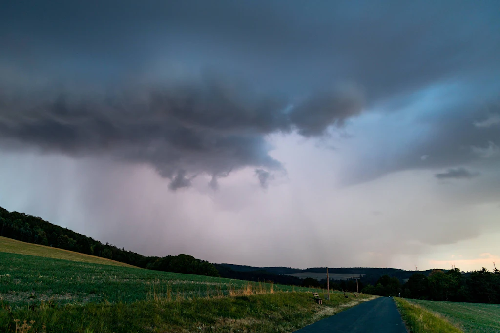 Regenschauer über einem Mittelgebirgszug: An diesem Montag entstehen über den süddeutschen Mittelgebirgen einzelne kräftige Gewitter mit Starkregen und stürmischen Böen. (Symbolbild)