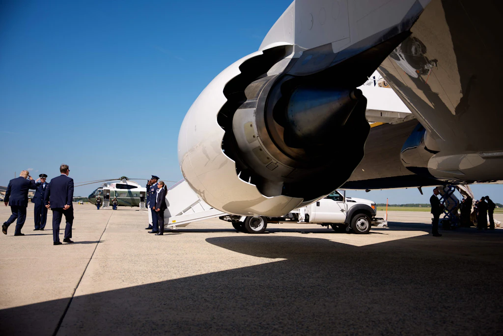 US-Präsident Donald Trump besteigt die Air Force One, während Besatzungsmitglieder an der ausgefahrenen Notrutsche arbeiten.
