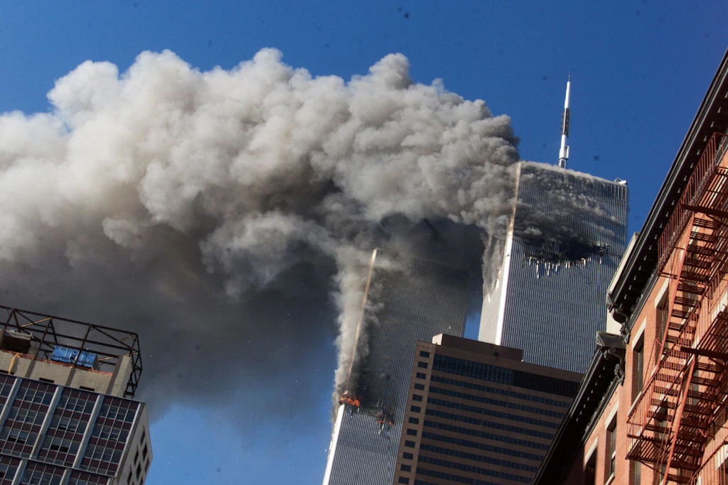 Rauch steigt aus den brennenden Zwillingstürmen des World Trade Centers auf.