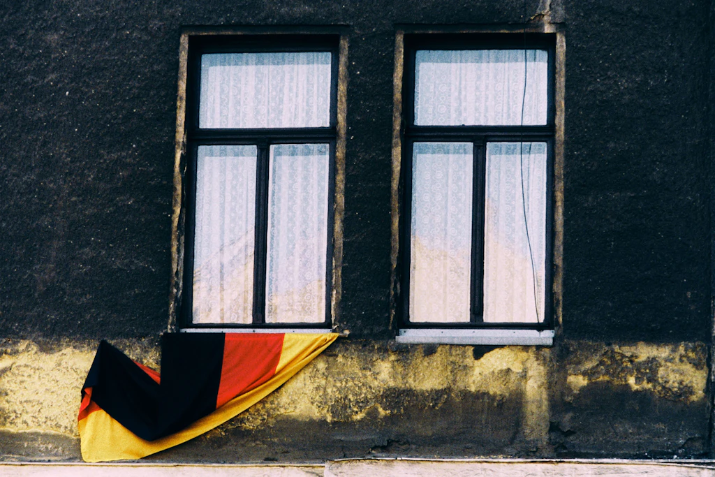 Ein Haus in der DDR im Februar 1990: Unter einem Fenster hängt die schwarz-rot-goldene Deutschlandflagge – nun ohne Hammer und Sichel.