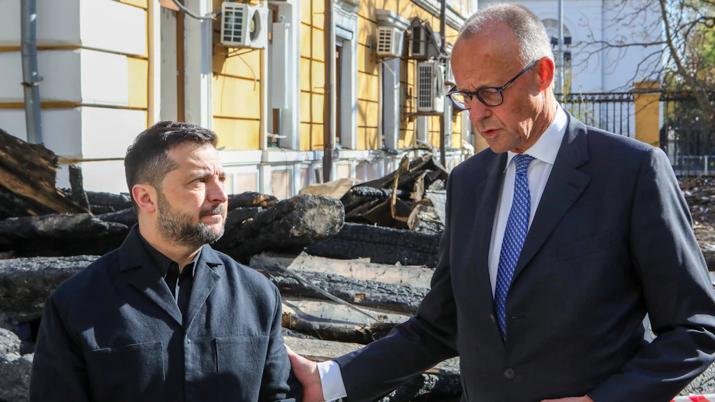 Bundeskanzler Friedrich Merz und der ukrainische Präsident Wolodymyr Selenskyj am 4. Oktober vor der von russischen Angriffen beschädigten Akademie der Wissenschaften in Kiew.