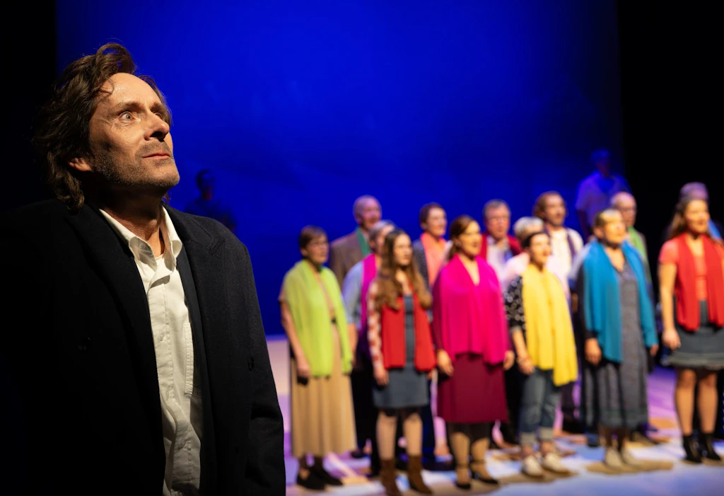 Plattdeutsche Bühne in Schwerin: Christoph Reiche steht vor Ensemble und Chor in der neuen Produktion „As in’n Häben“.